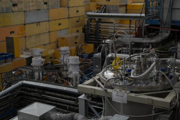 Complex scientific machinery with pipes and yellow blocks