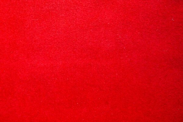 A vibrant red felt texture with a soft matte finish