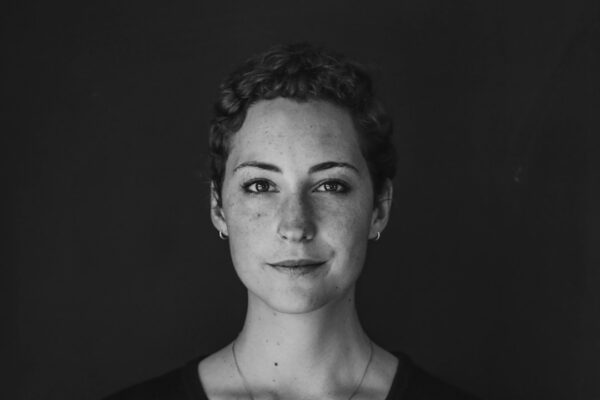 grayscale photo of woman wearing necklace and top