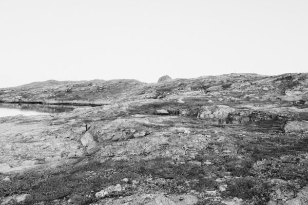 a black and white photo of rocks and water