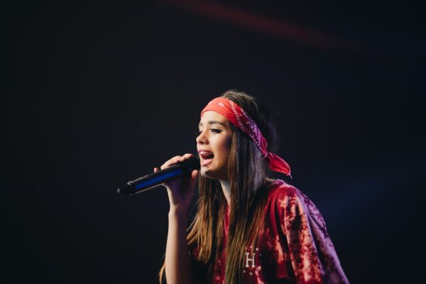 woman in red dress holding microphone
