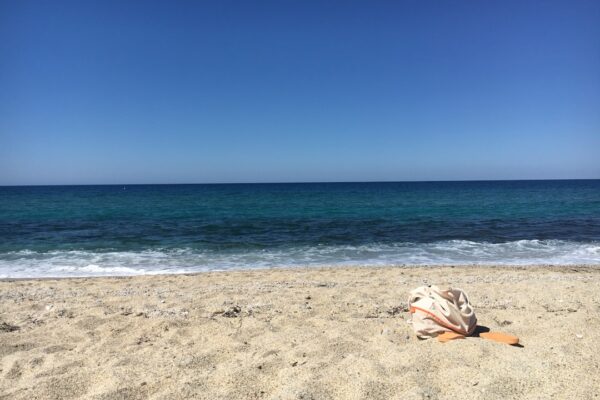 white and brown textile on beach during daytime