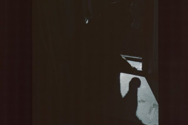 Dark silhouette of a person near a window