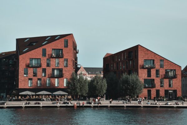 brown concrete building beside body of water during daytime